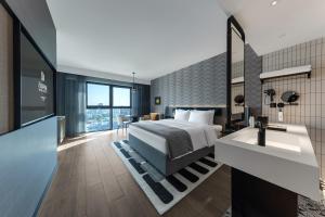 a hotel room with a bed and a sink at Wanda Moments Hotel Beijing Dongba in Beijing
