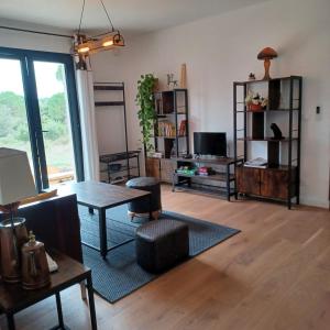 a living room with a table and a dining room at GITE Mourèzeva in Mourèze