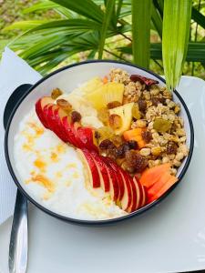 a pan filled with fruit and vegetables on a table at Tropical Villa - Weligama in Weligama