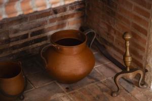 a clay pot and a pole next to a brick wall at Señorío de Ves in Casas de Ves +73 photos