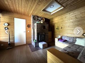a living room with a couch and a fireplace at Detached house, 3 bedrooms, Lappeenranta in Lappeenranta +8 photos