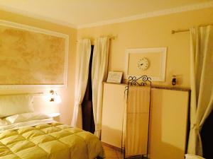 a bedroom with a bed and a clock on the wall at Hotel Martin in Volpiano