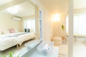 A bed or beds in a room at Miraie Yokkaichi Simizucho 2