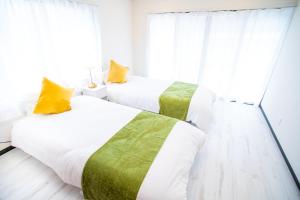 A bed or beds in a room at Miraie Yokkaichi Simizucho 2