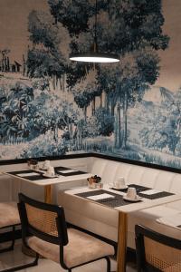a dining room with a table and a wall mural at Hotel Cristal Porto in Porto +49 photos