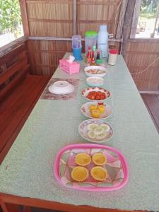 a table with plates of food on top of it at Oridek homestay in Kri