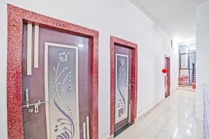 a corridor with three doors in a room at Hotel O Sai Anant in Bilāspur +30 photos