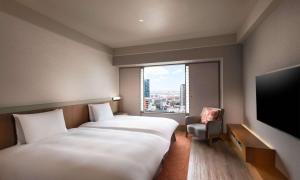 Кровать или кровати в номере Hilton Osaka Hotel