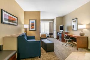 a hotel room with a desk and a computer at Comfort Suites in Forrest City