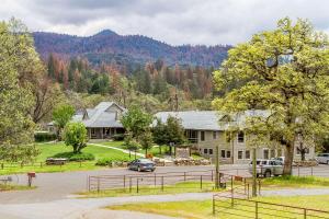 a house with a car parked in a parking lot at Sierra Sky Ranch in Oakhurst
