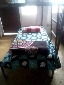 two twin beds in a room with a quilt at Himalayan Bed & Breakfast, Triund Trekking and Snowline Trekking Hostel in Dharamshala +13 photos