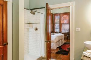 a bathroom with a shower and a bed in a room at Hotel Napa Valley, an Ascend Collection Hotel in Napa +39 photos