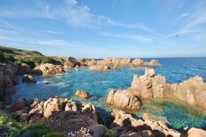 a pool of water with rocks in the ocean at ISA-Residence with swimming-pool in Costa Paradiso, apartments 6 beds with private outdoor area in Costa Paradiso