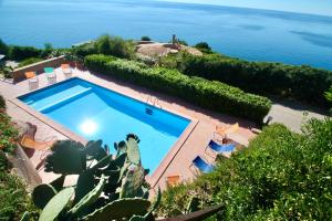 an overhead view of a swimming pool next to the ocean at ISA-Residence with swimming-pool in Costa Paradiso, apartments 6 beds with private outdoor area in Costa Paradiso