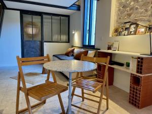 a living room with a table and two chairs at "La Forge" avec parking privé in Sète