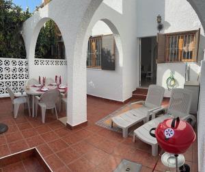 a patio with a table and chairs on a patio at Villa Corazon in Torrevieja