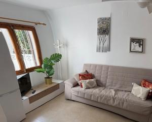 a living room with a couch and a window at Villa Corazon in Torrevieja
