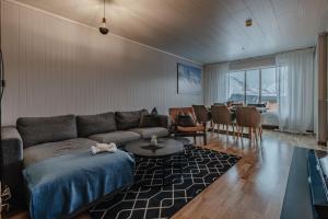 a living room with a couch and a table at Longyearbyen Apartment in Longyearbyen