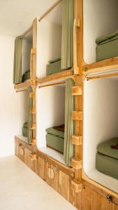 a room with four bunk beds in it at Lost Inn Kuta Capsule Hostel in Kuta Lombok