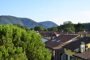 a group of houses with mountains in the background at B&B La Bella Lucca in Lucca