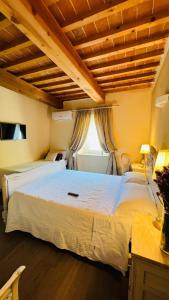 a bedroom with a large white bed in a room at B&B La Bella Lucca in Lucca