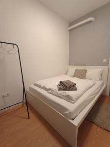a bed with a bag on it in a room at Lang's square apartment in Zagreb
