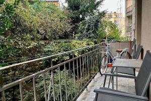 a balcony with a bike parked on a railing at Lang's square apartment in Zagreb