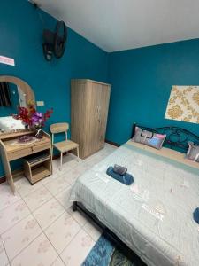 a bedroom with a bed and a desk and a table at Ciao Bella GuestHouse & Bistro in Kata Beach