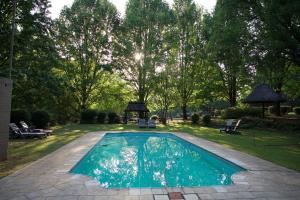 a swimming pool in the middle of a yard at Berghaven Cottages in Winterton