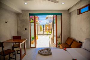 a living room with a bed and a door to a patio at Pamoja Beach Stays Hotel in Jambiani in Jambiani