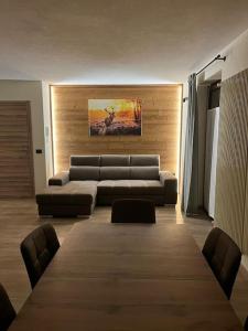 a living room with a couch and a large table at Al Bait de Luiseto in Bormio