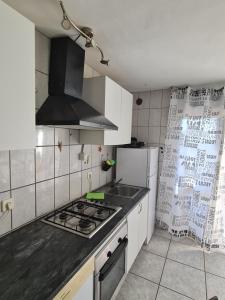 a kitchen with a stove and a refrigerator at Casa Eowyn in Puerto del Carmen