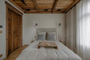 a bedroom with a large bed with a table on it at Villa Vena in Zakopane