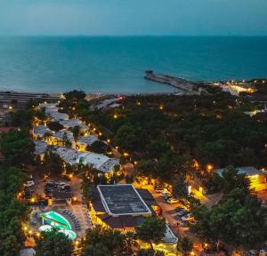 an overhead view of a city at night with the ocean at Villaggio Porticello Mare in Vieste