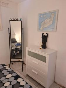 a bedroom with a dresser and a mirror at Casa Eowyn in Puerto del Carmen +15 photos