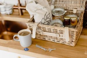 a basket with a cup of coffee on a counter at Flore House in Flore