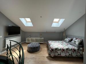 a bedroom with a bed and a couch and skylights at Gran Reserva Cuzcurrita in Cuzcurrita-Río Tirón +36 photos