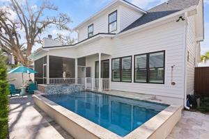 a house with a swimming pool in front of it at Take It Easy - 104 Gould Street in King City