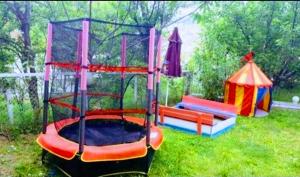 a playground with a play set in the grass at Guest House Sofia in Sandanski