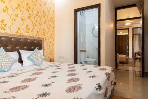 a bedroom with a bed and a window and a bathroom at Rosa Heritage Abode - 3BHK Spacious Home in Jaipur +12 photos