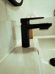a sink with a black faucet in a bathroom at Domek na szlaku in Szklarska Poręba +21 photos