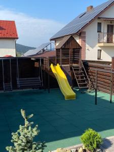 a playground with a slide on a house at Five House in Skhidnitsa +114 photos
