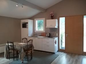 a kitchen with a table and a kitchen with a table and chairs at T3 cadre champêtre Saint Jean de Luz in Saint-Pée-sur-Nivelle
