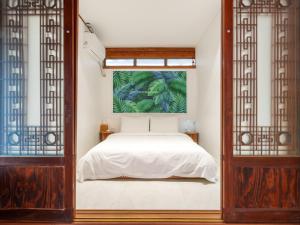 a bedroom with a bed and a painting on the wall at Exclusive House Hanok Stay 'Soo Hanok' in Suncheon