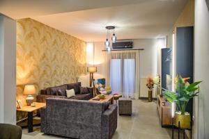 a living room with a couch and a table at Nychome in Ayía Marína