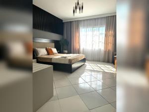 a bedroom with a bed and a large window at Cozy apartment in Delta Sharm in Sharm El Sheikh