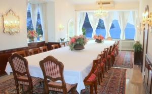 a large dining room with a long table and chairs at Barony romantic-residence in Lugano +120 photos