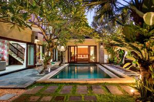 a pool in the backyard of a house with trees at 6-BR Private Pool Samudra Villa Tiga Umalas 10min to Canggu Beach in Umalas