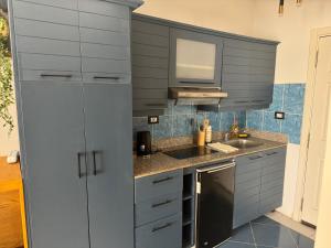 a kitchen with gray cabinets and a sink at Cozy apartment in Delta Sharm in Sharm El Sheikh