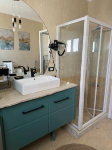 a bathroom with a sink and a shower at Cozy apartment in Delta Sharm in Sharm El Sheikh